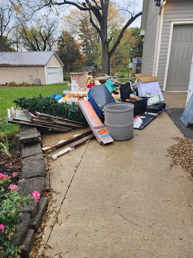 Dumpster being loaded with debris for 12 Yard Dumpster Rental in Frostburg